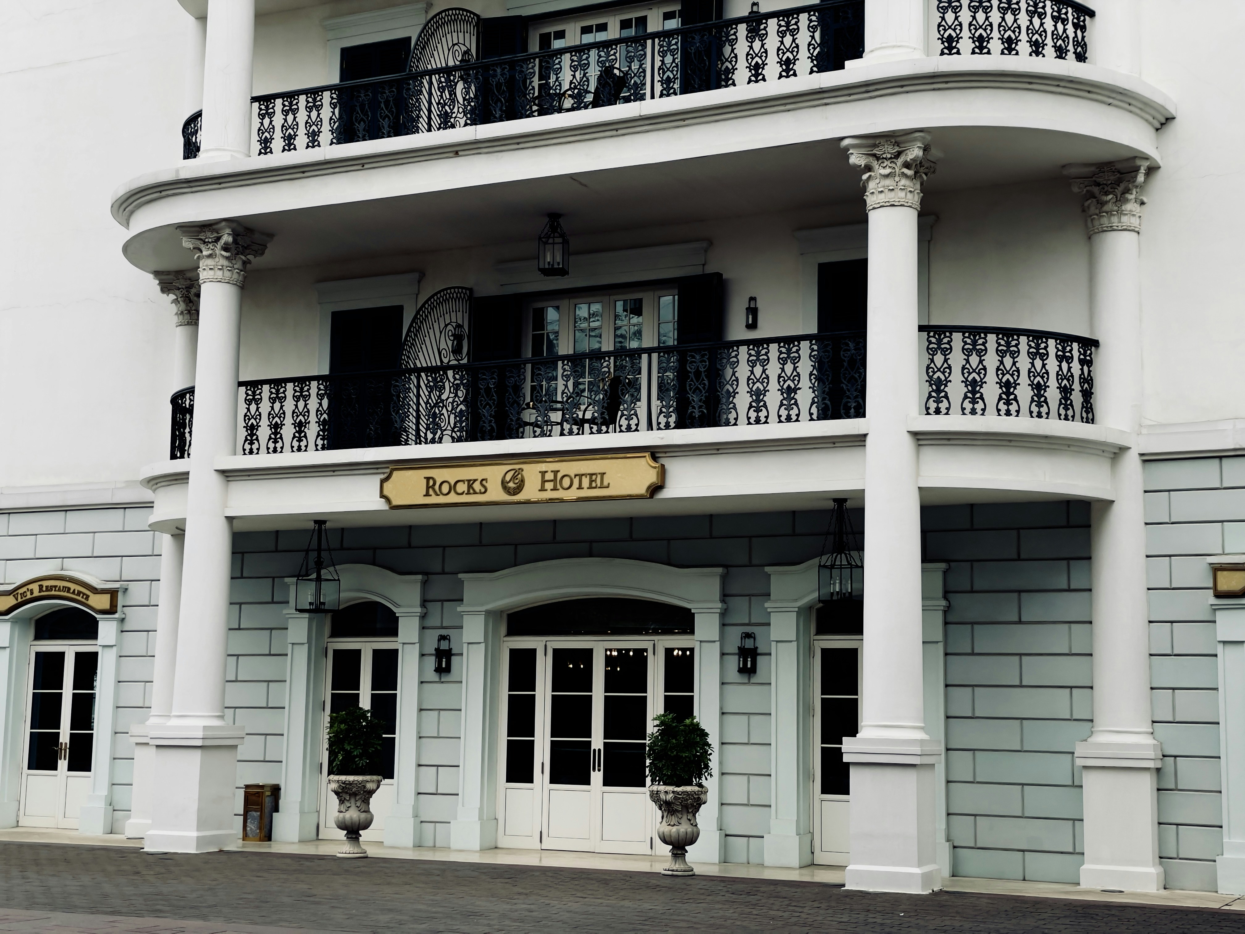 Stop image for Miami to Key West: 3-Day Budget-Friendly Adventure - a white building with a balcony and balconies -  in Florida Keys, South Florida - Photo by Kevin Xing on Unsplash