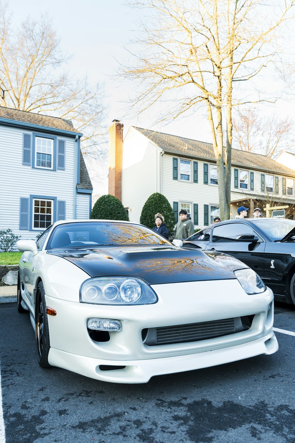 a white sports car parked in a parking lot