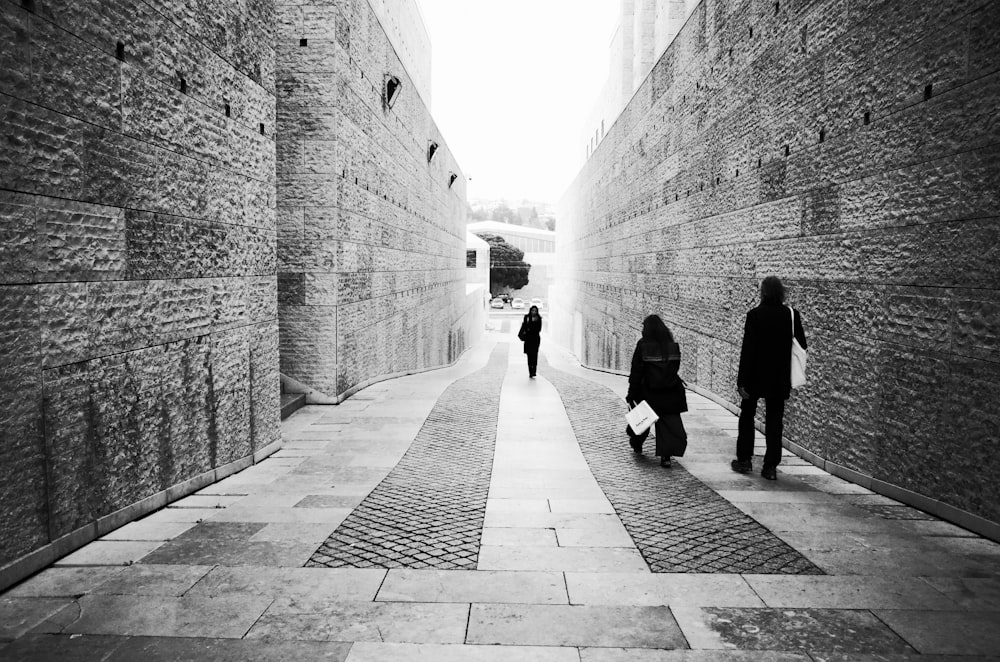 a couple of people that are walking down a street