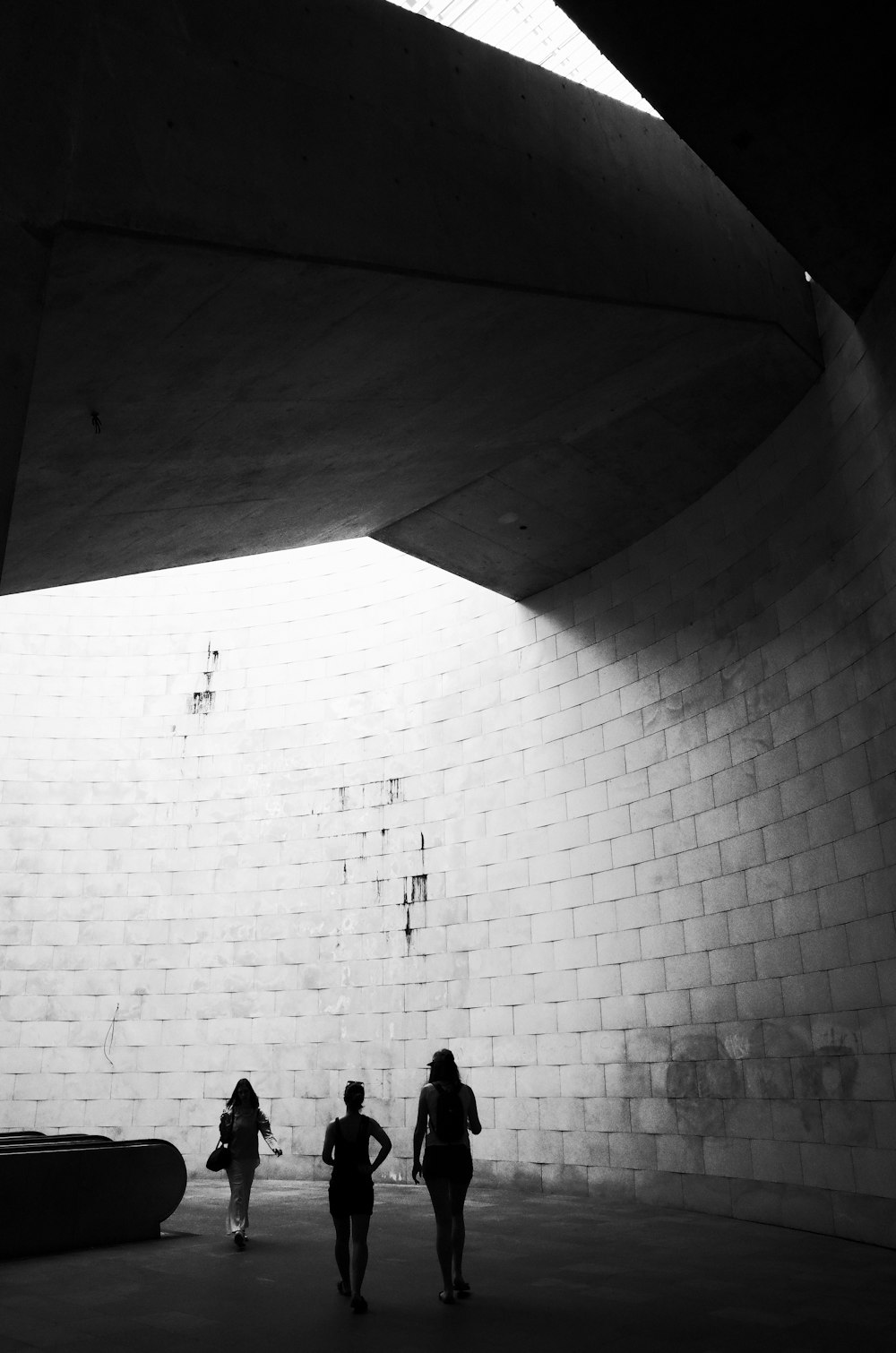 a couple of people that are walking under a bridge