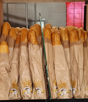 a bunch of baguettes that are sitting on a shelf