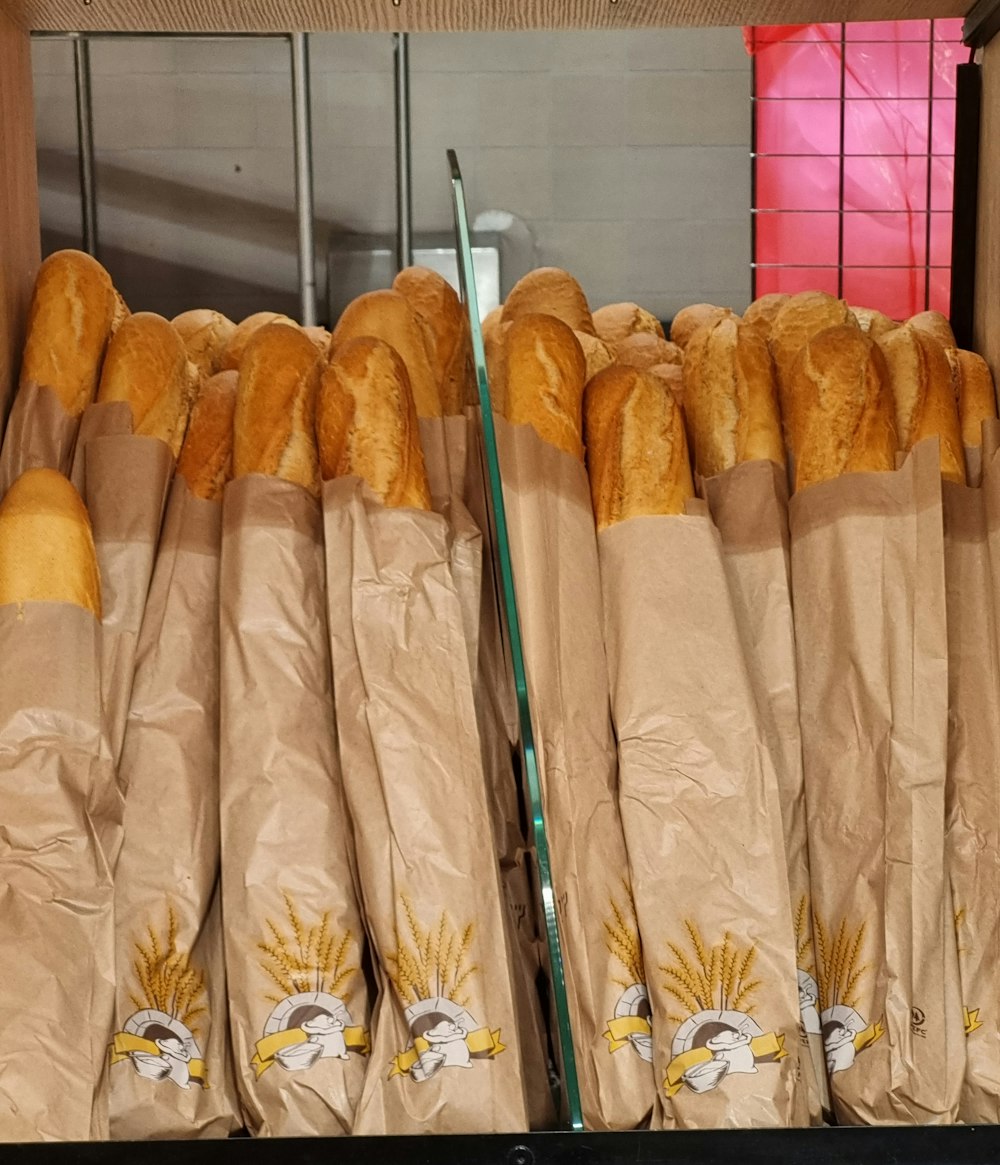 a bunch of baguettes that are sitting on a shelf