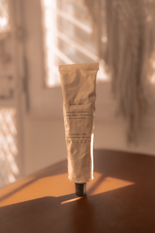 a tube of cream sitting on top of a wooden table