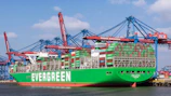 a large green cargo ship in a harbor