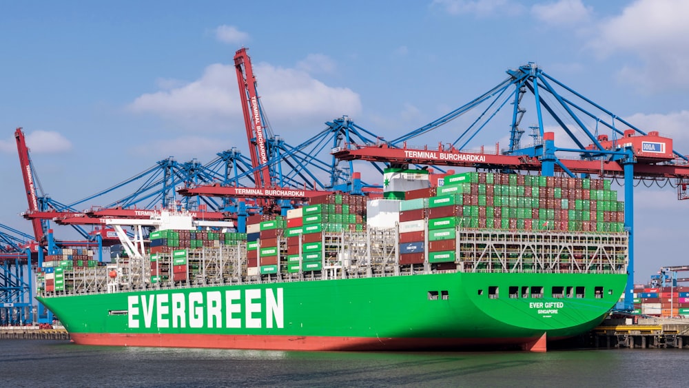 a large green cargo ship in a harbor