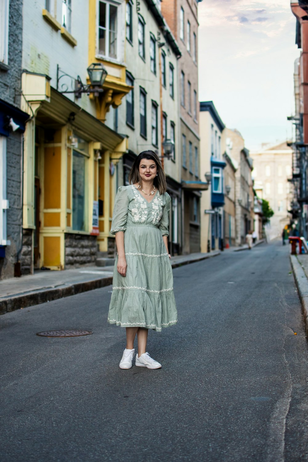 a woman standing in the middle of a street