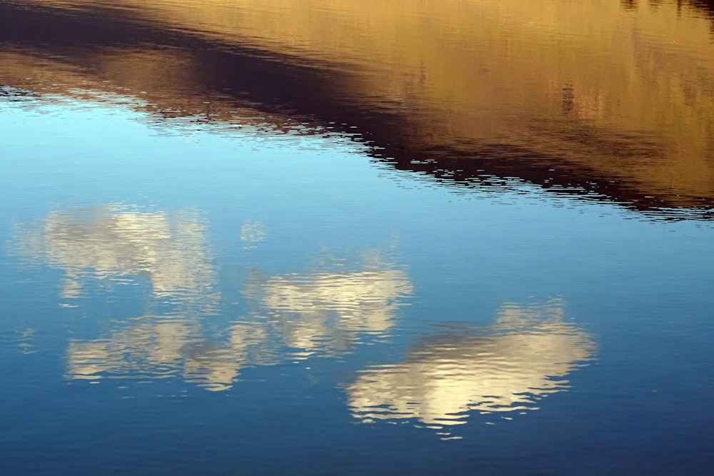 a body of water that has a bunch of clouds in it