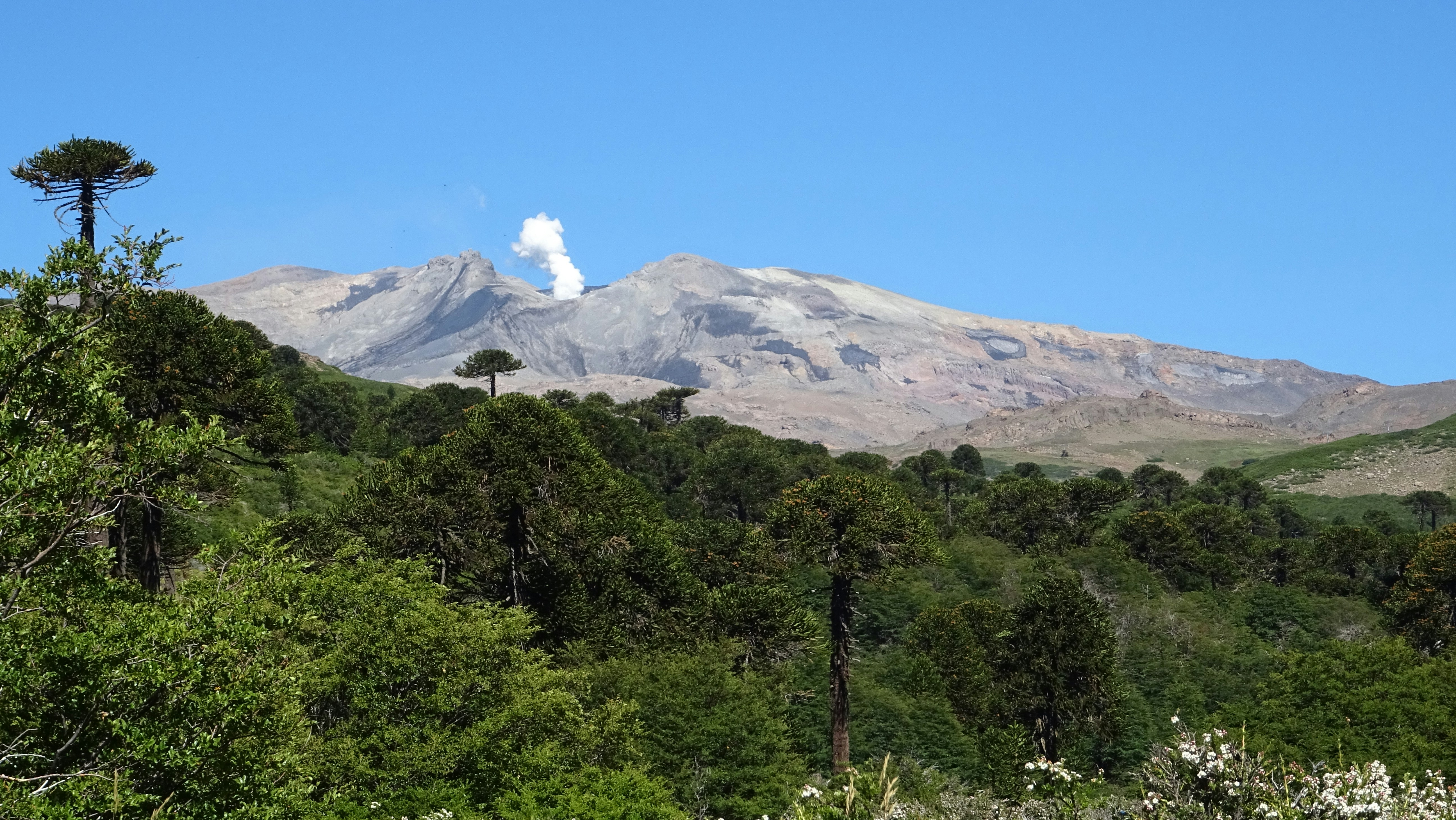 a view of a mountain with a cloud in the sky