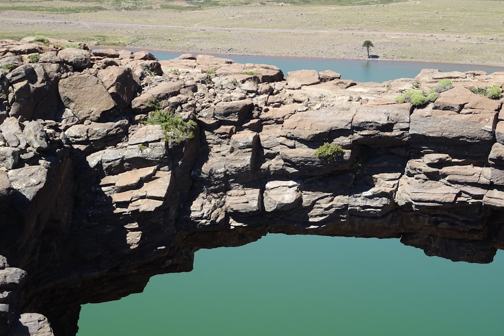 a person standing on a bridge over a body of water