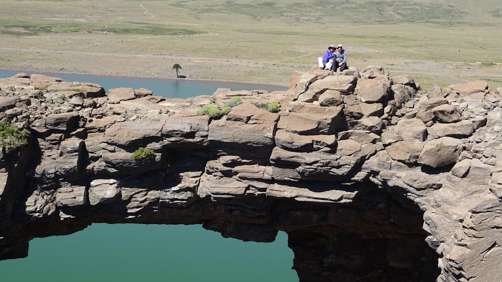 a couple of people standing on top of a bridge