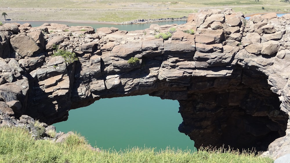 a large rock bridge over a body of water