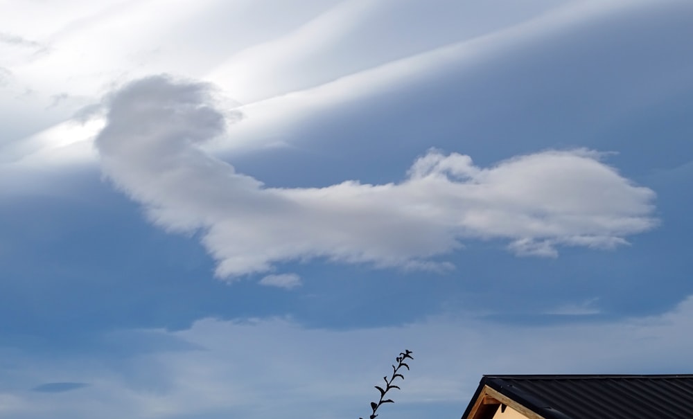 a cloud is in the sky above a house