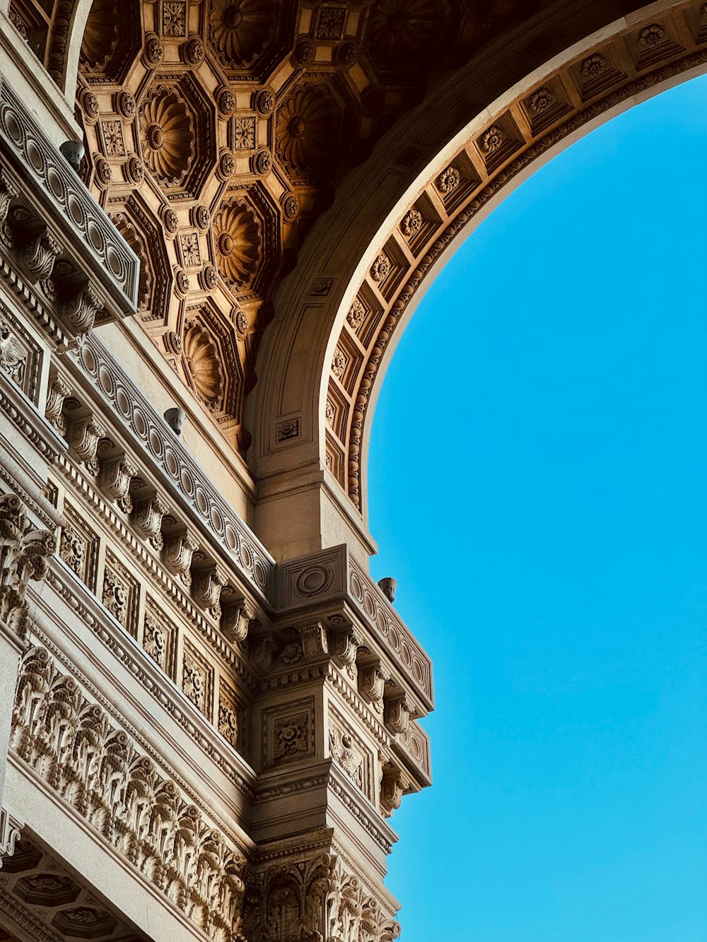 a view of a blue sky through an arch in a building