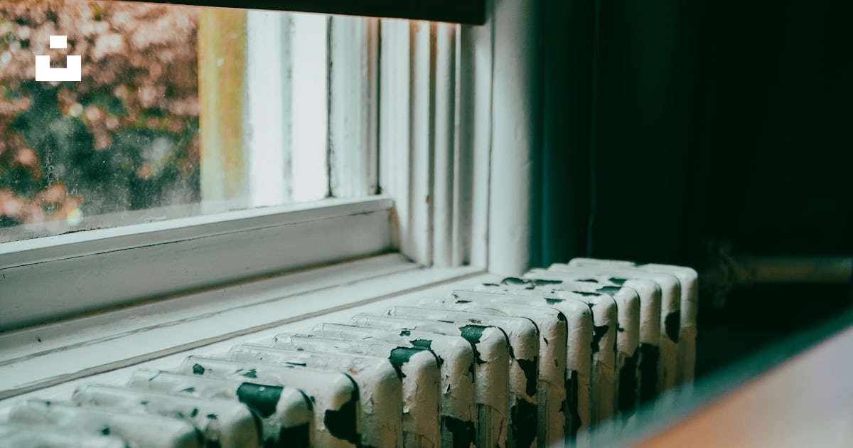 A close up of a radiator in front of a window photo – Free Windowsill ...