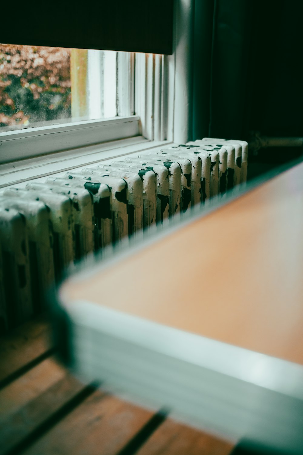 a close up of a radiator in front of a window