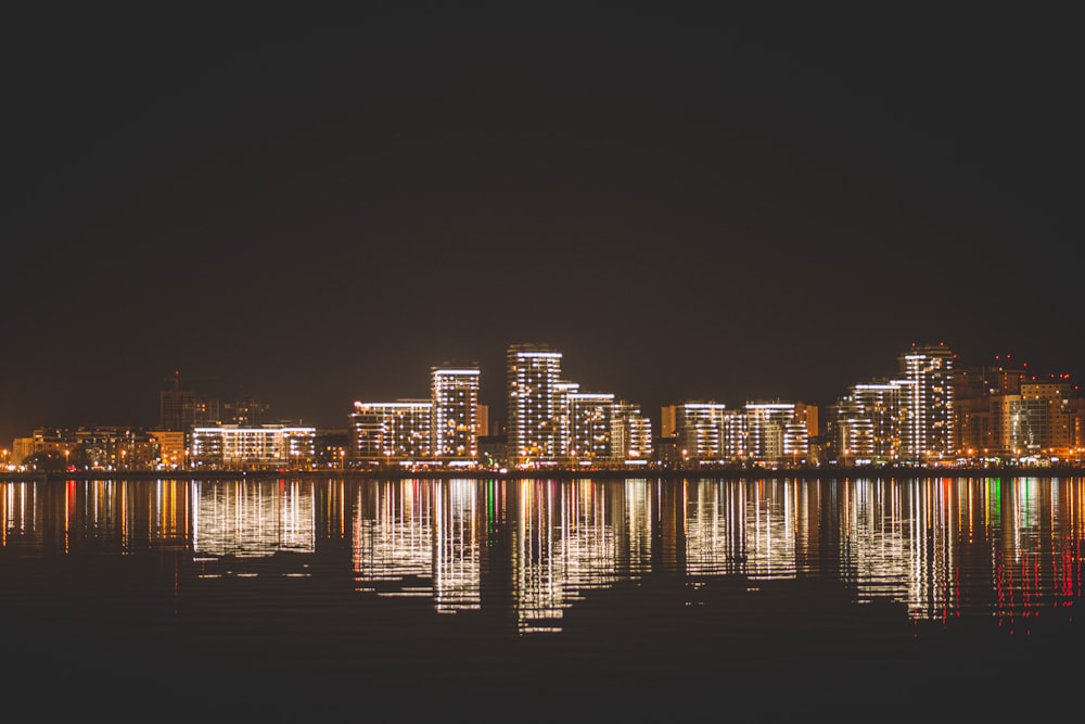 a city at night reflected in the water