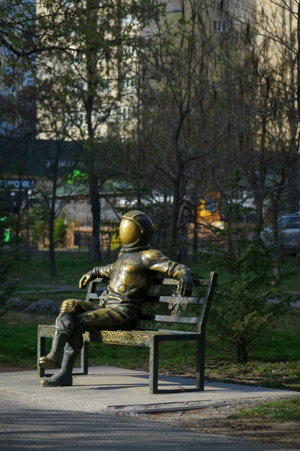 a statue of a man sitting on a bench