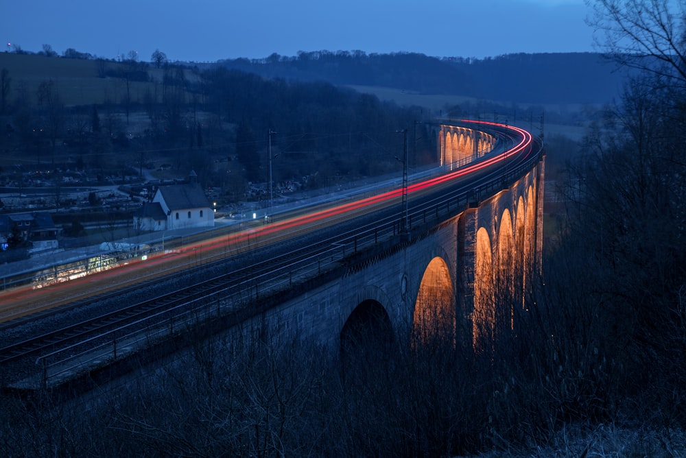 a long exposure photo of a bridge at night