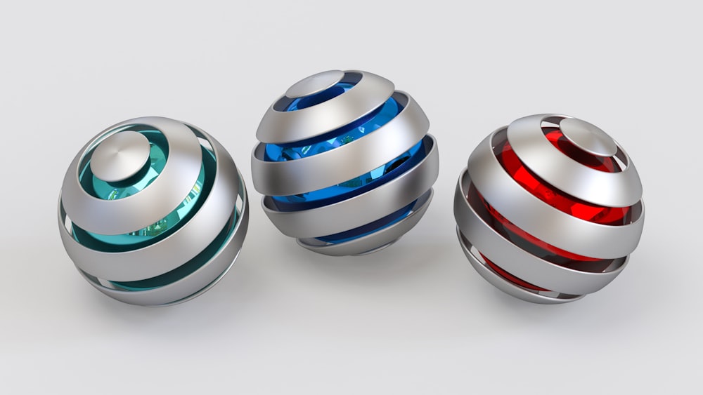 three shiny balls with different colors on them