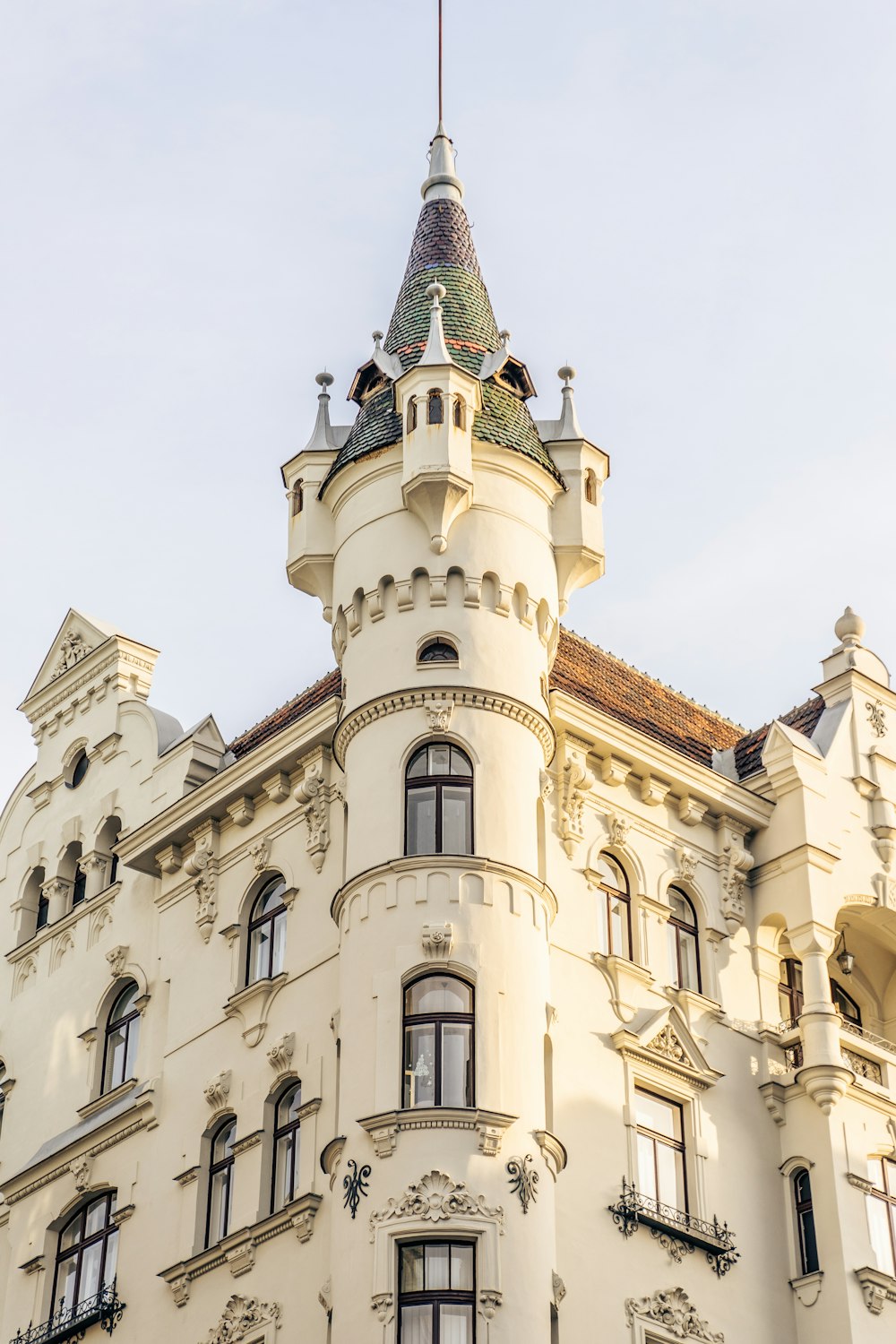 a tall white building with a clock on the top of it