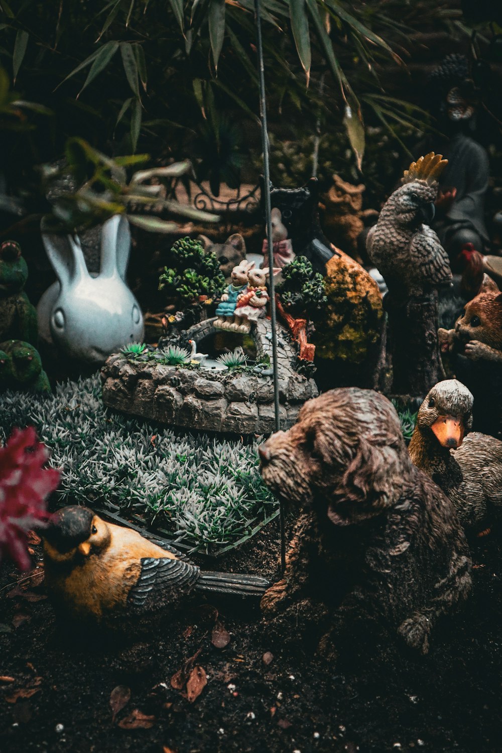 a group of figurines sitting on top of a lush green field