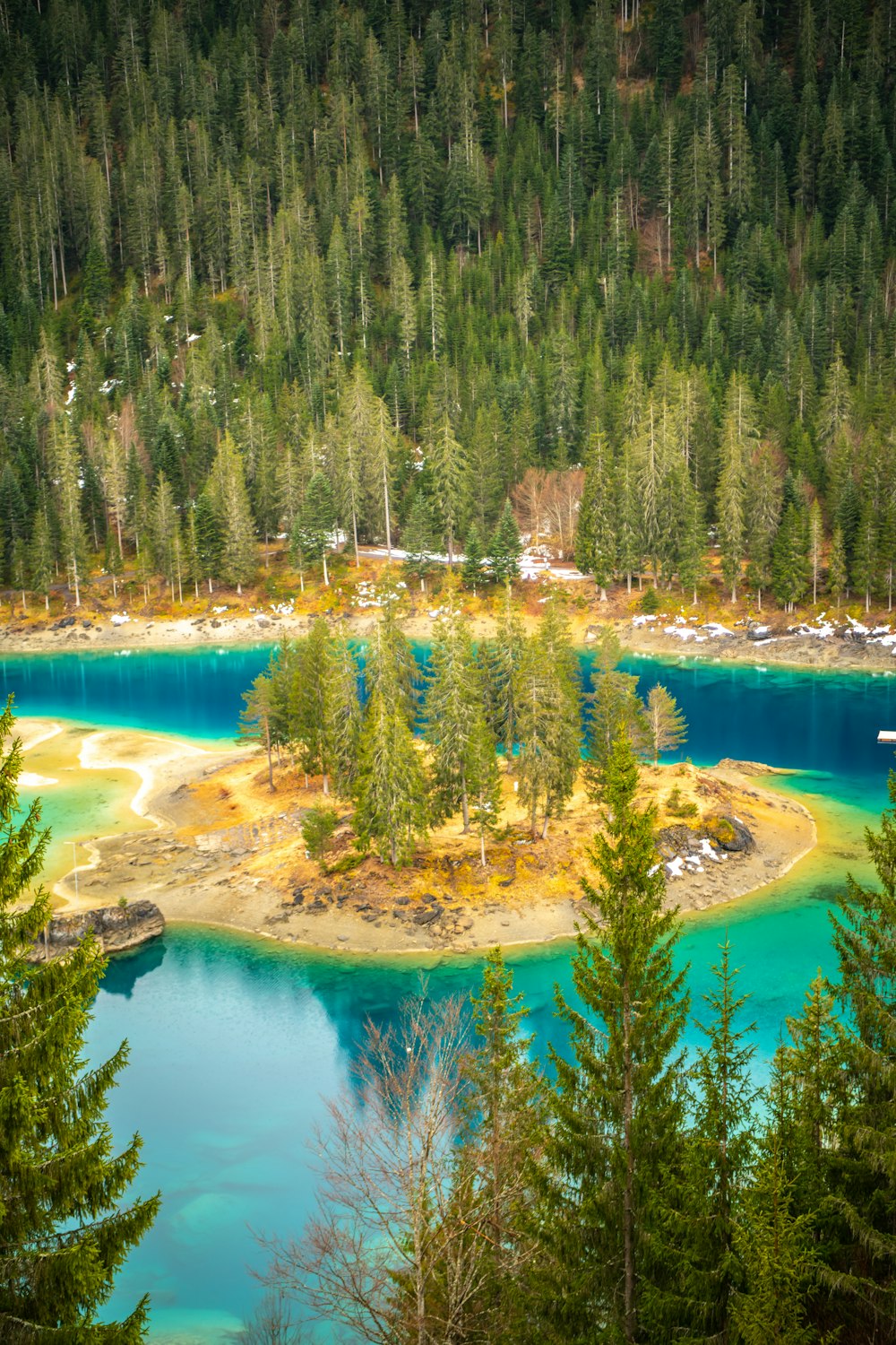 a small island in the middle of a lake surrounded by trees