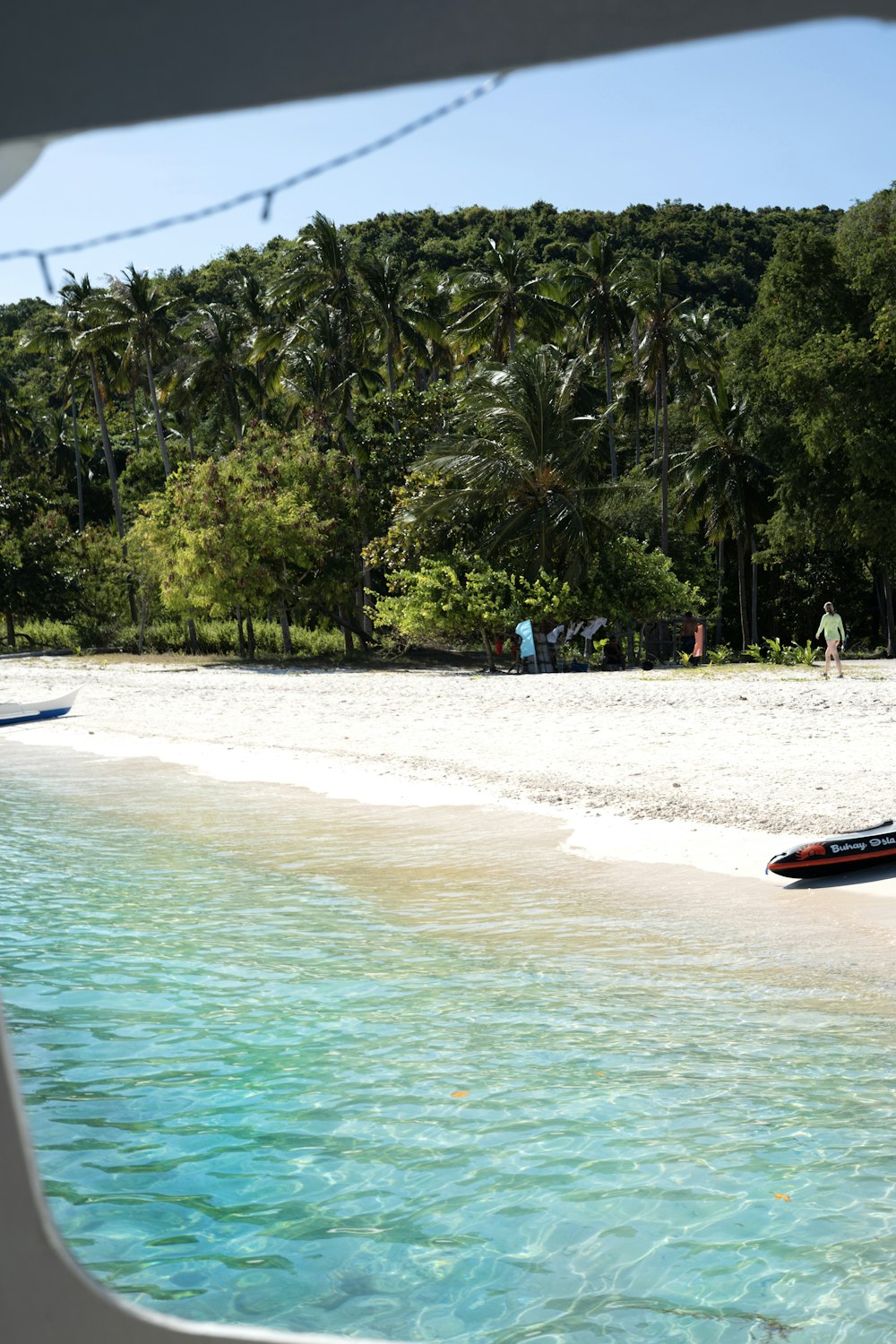 a boat sitting on top of a sandy beach