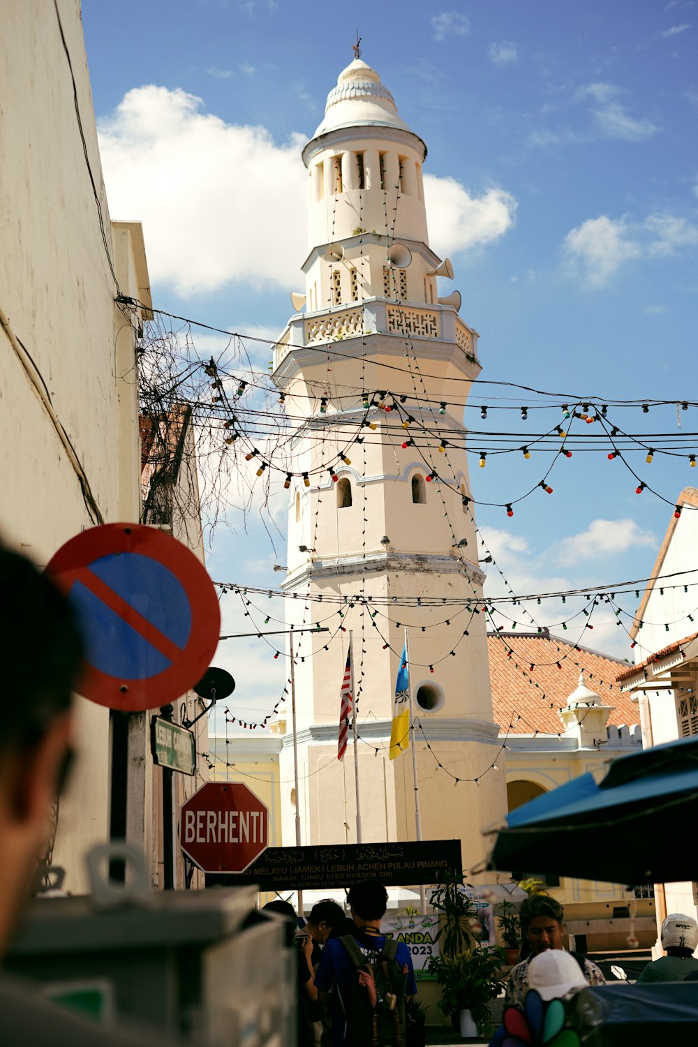 a tall white tower with a clock on it's side