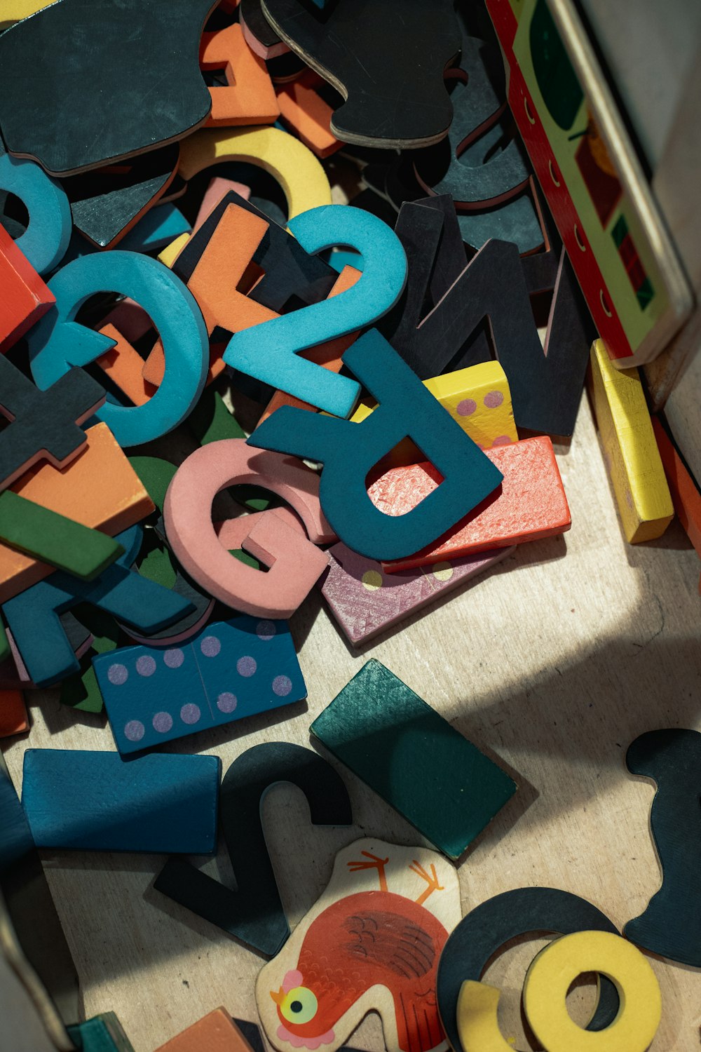 a pile of colorful wooden letters and numbers