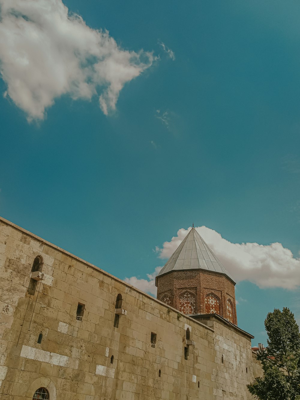 a tall brick building with a sky background