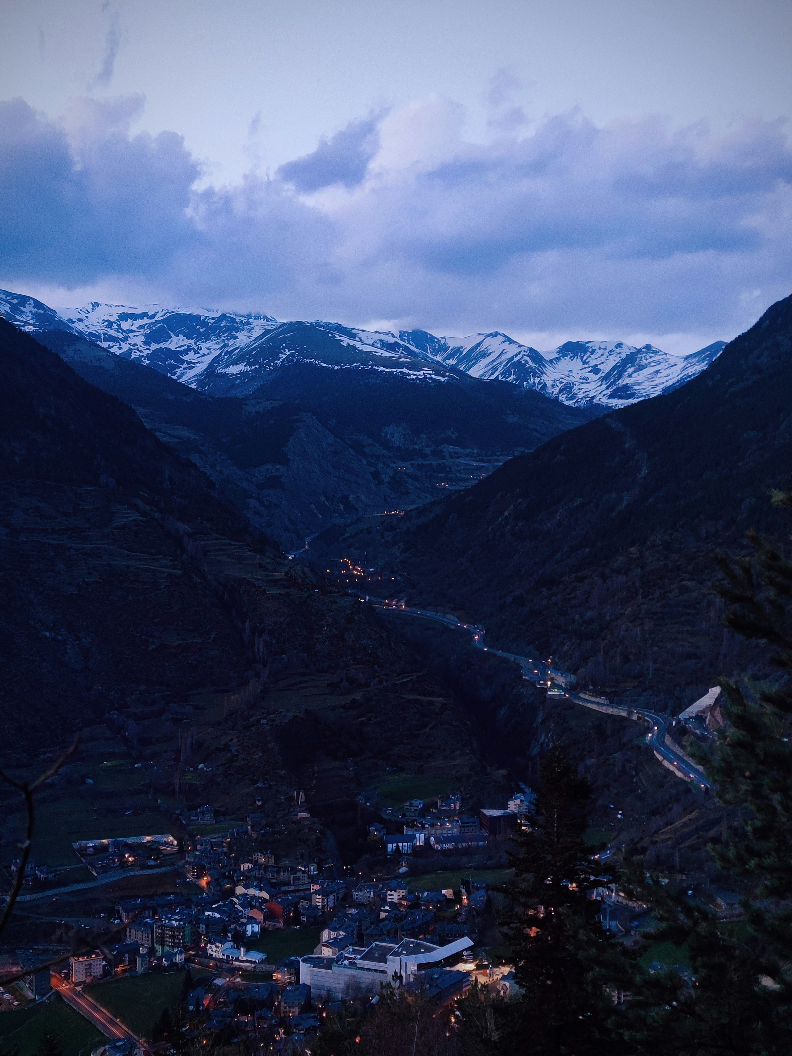 a scenic view of a town in the mountains