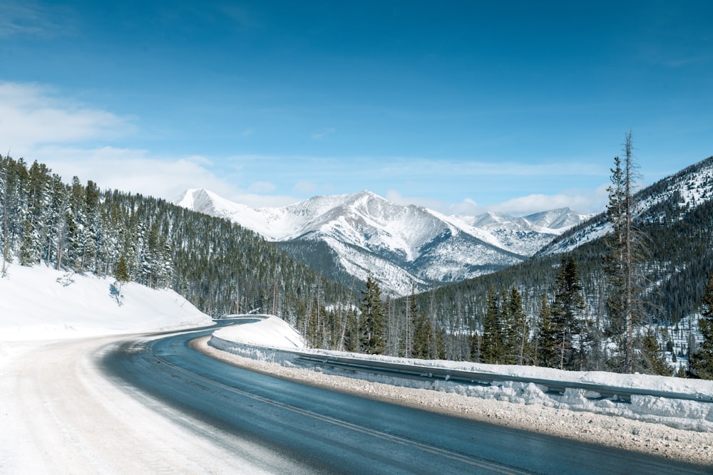 a road in the middle of a snowy mountain range