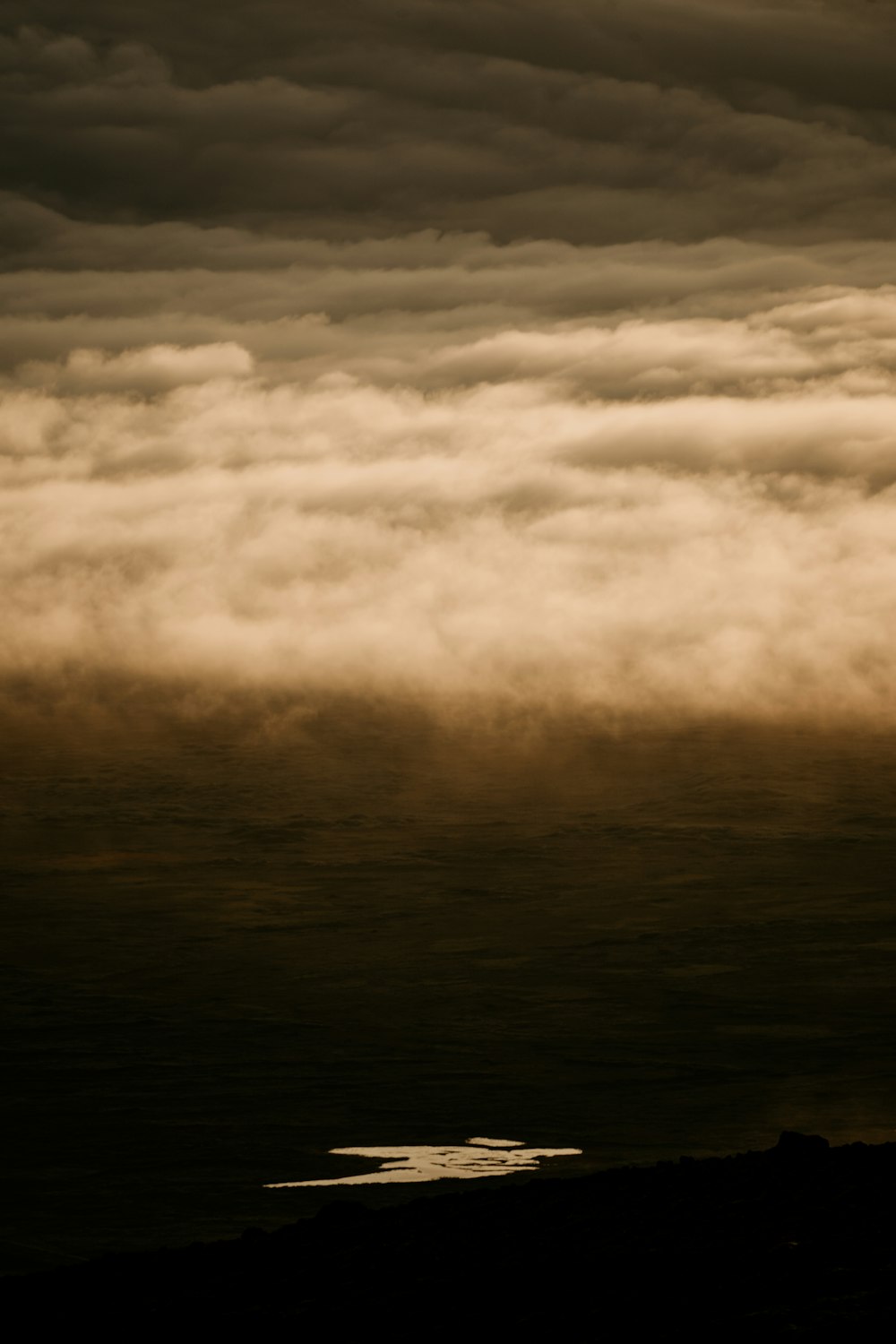 a plane flying in the sky with a lot of clouds