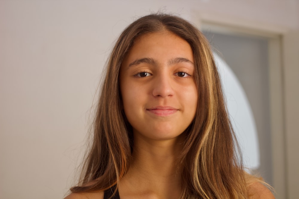 a woman with long hair and a black tank top