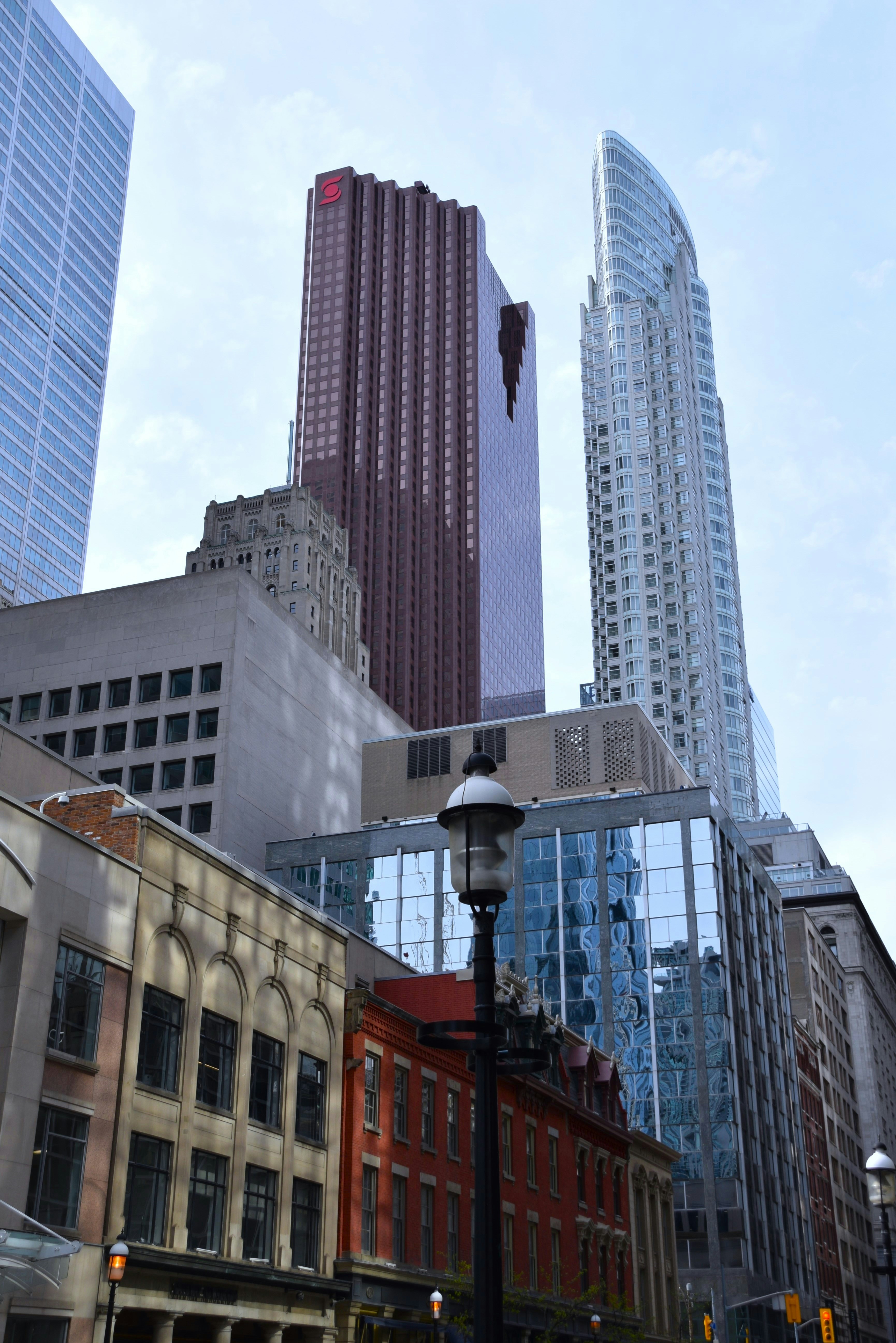 a city street with tall buildings in the background