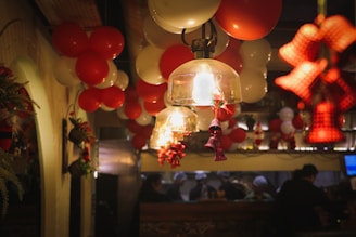 a bunch of balloons hanging from a ceiling