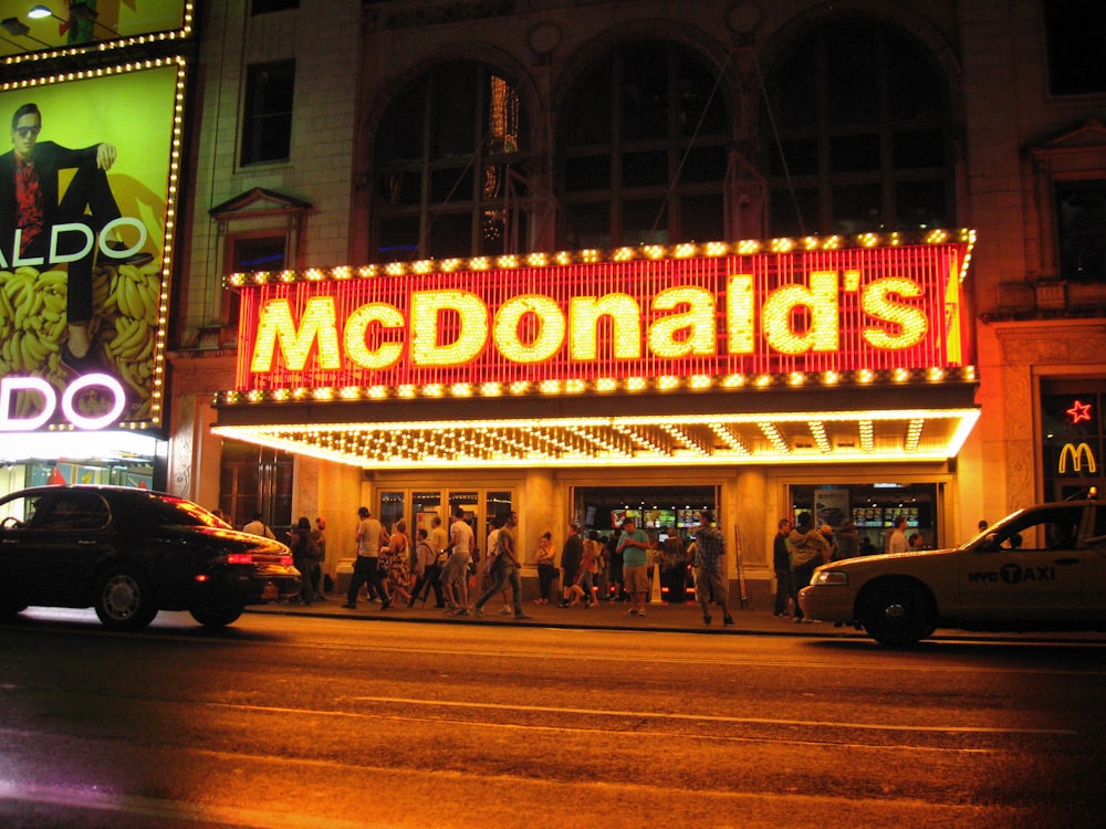 a neon sign that reads mcdonald's on the side of a building