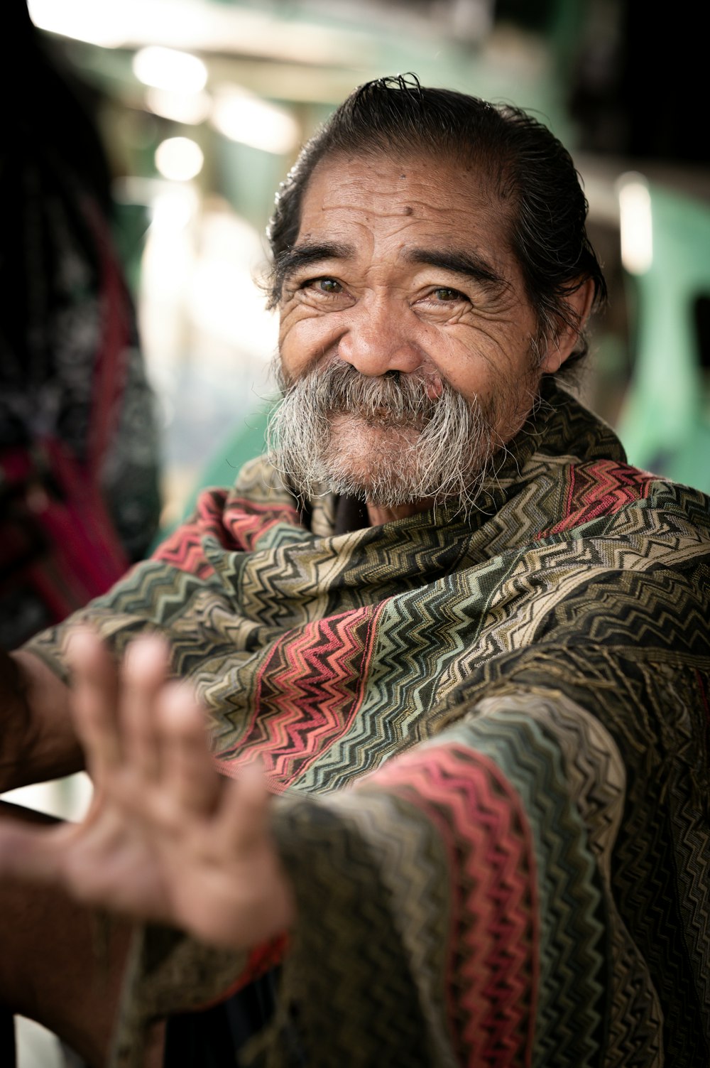 a man with a beard and a scarf on