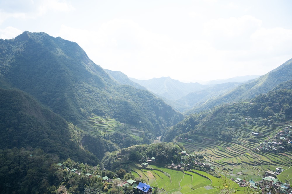 a view of a valley with mountains in the background