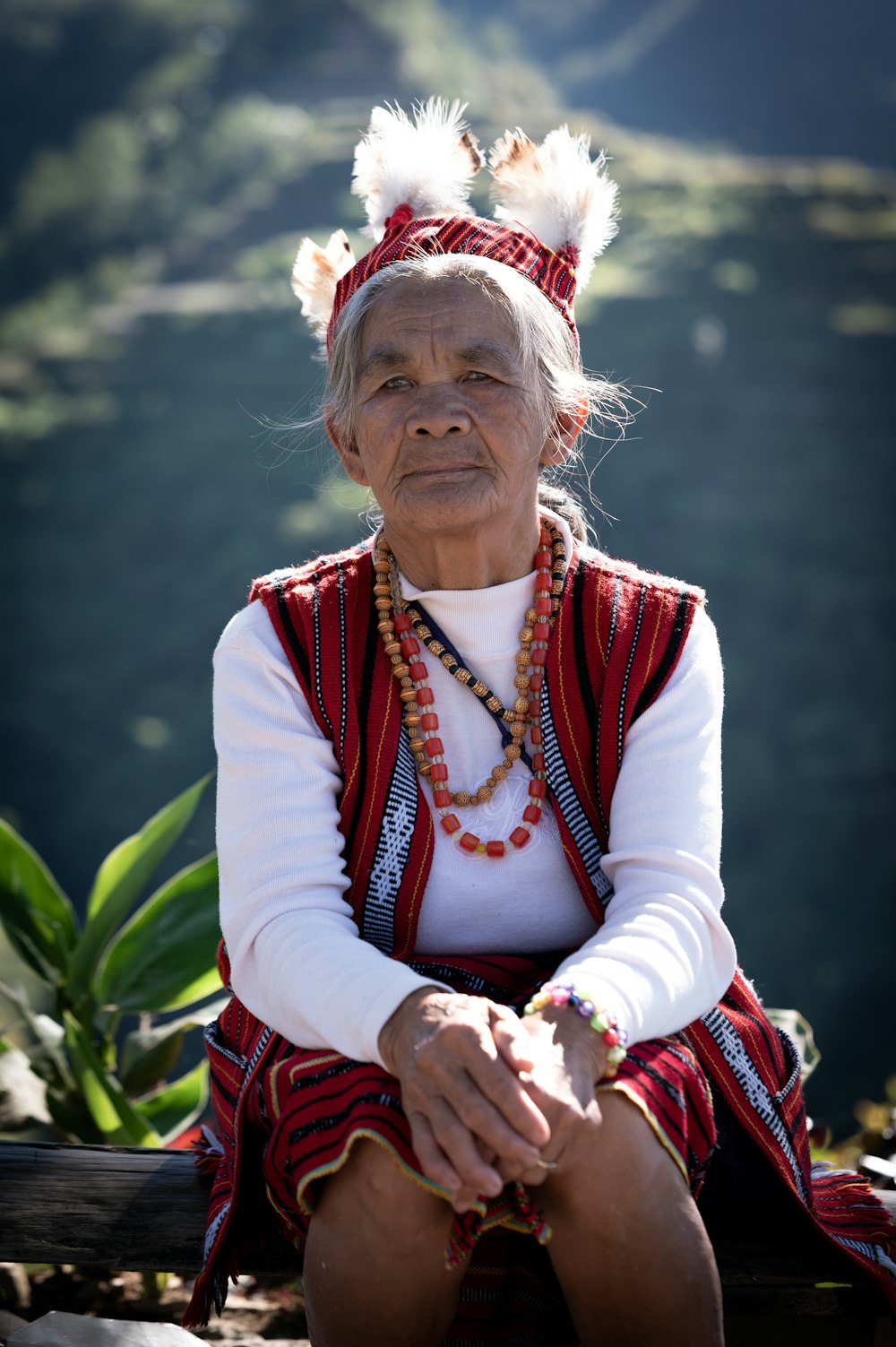 a native american woman sitting on a bench