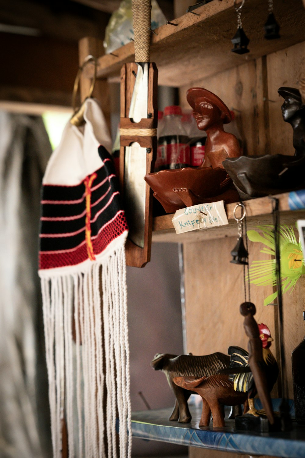 a wooden shelf filled with figurines and other items