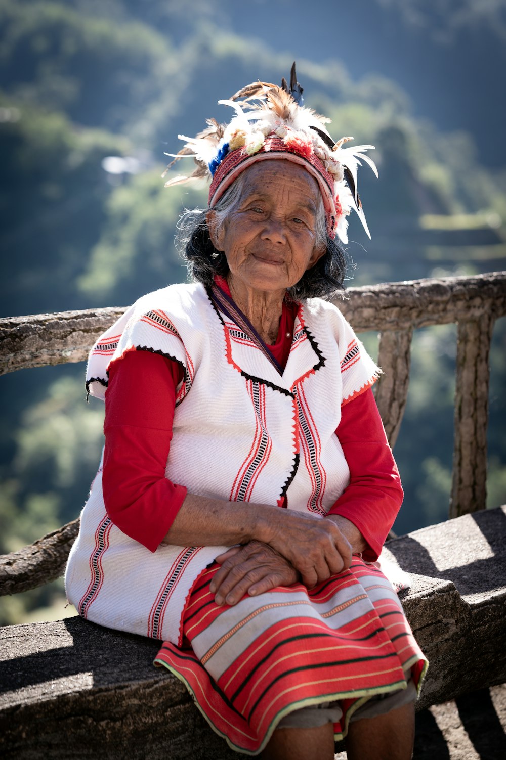 a native american woman sitting on a wooden bench