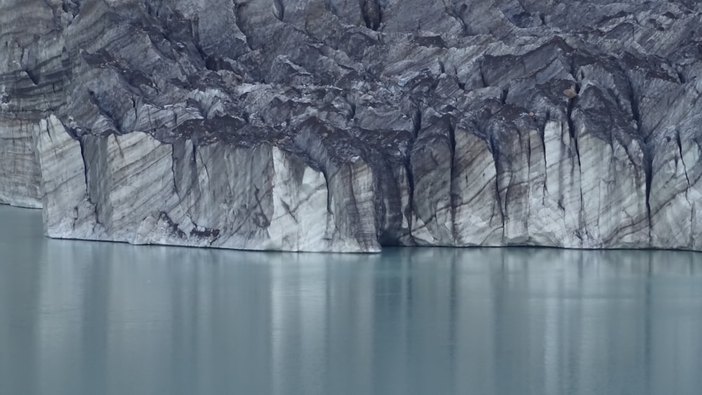 a large iceberg is in the middle of a body of water