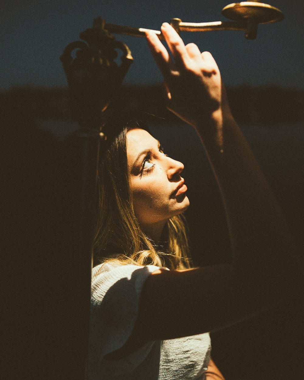 a woman is holding a spoon above her head