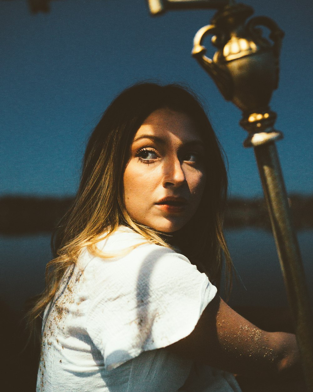 a woman standing next to a street light