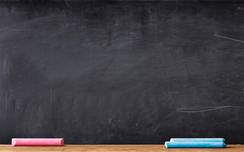 a blackboard with a chalkboard and some colored pencils