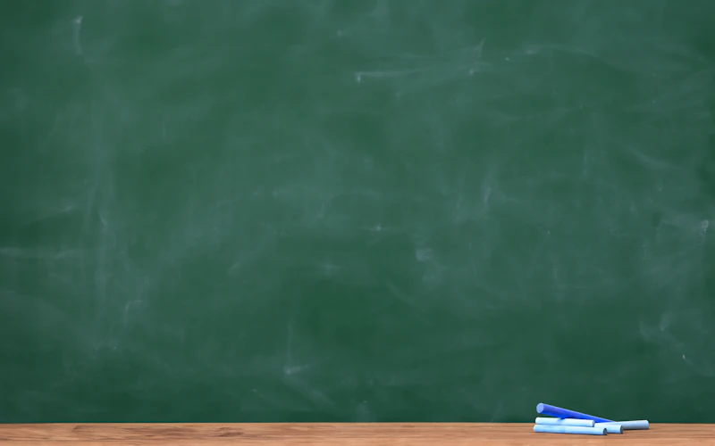 Empty school classroom with chalkboard
