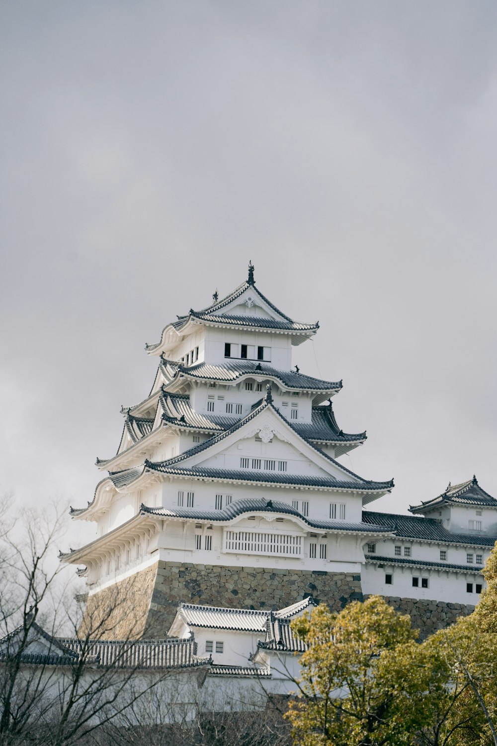 a tall white building sitting on top of a hill