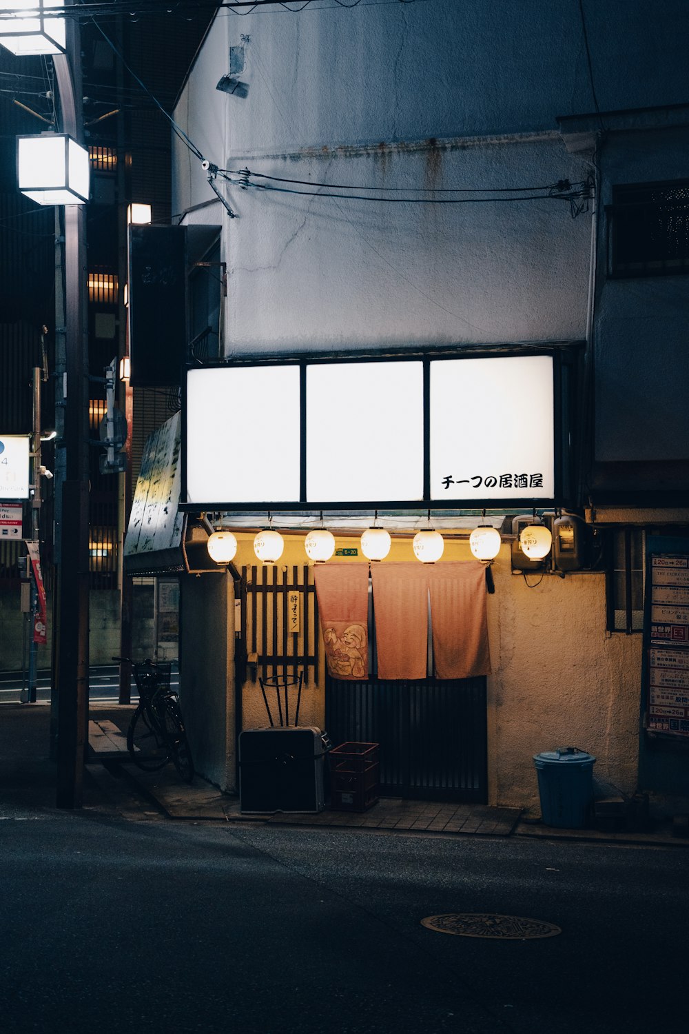 a street corner with a sign and lights