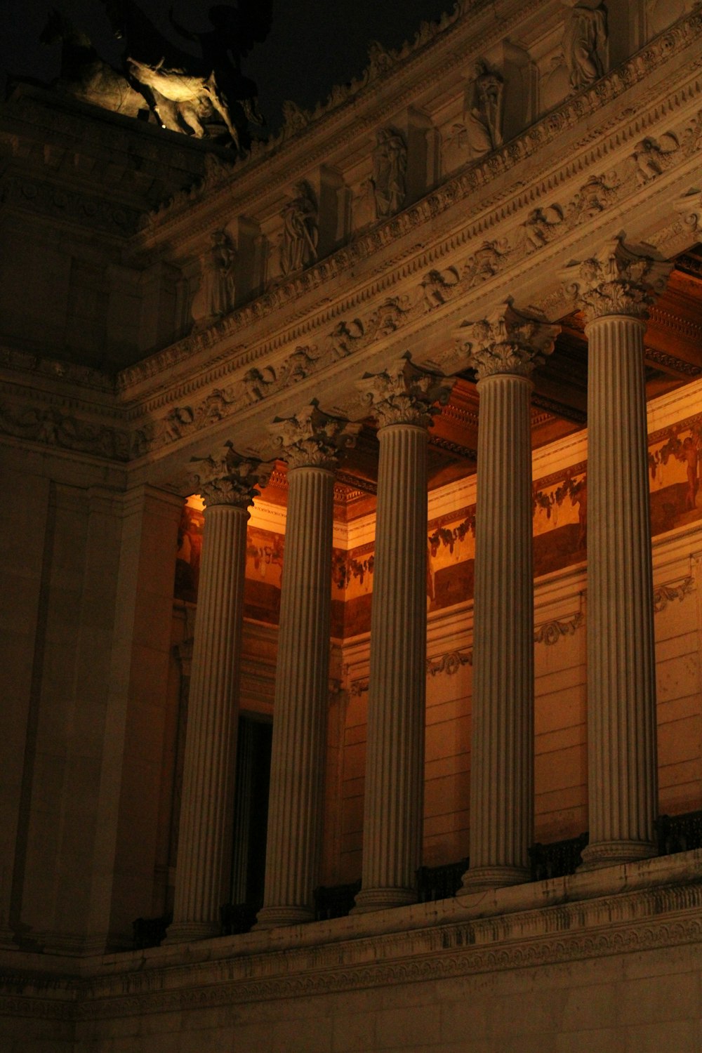 a building with columns lit up at night